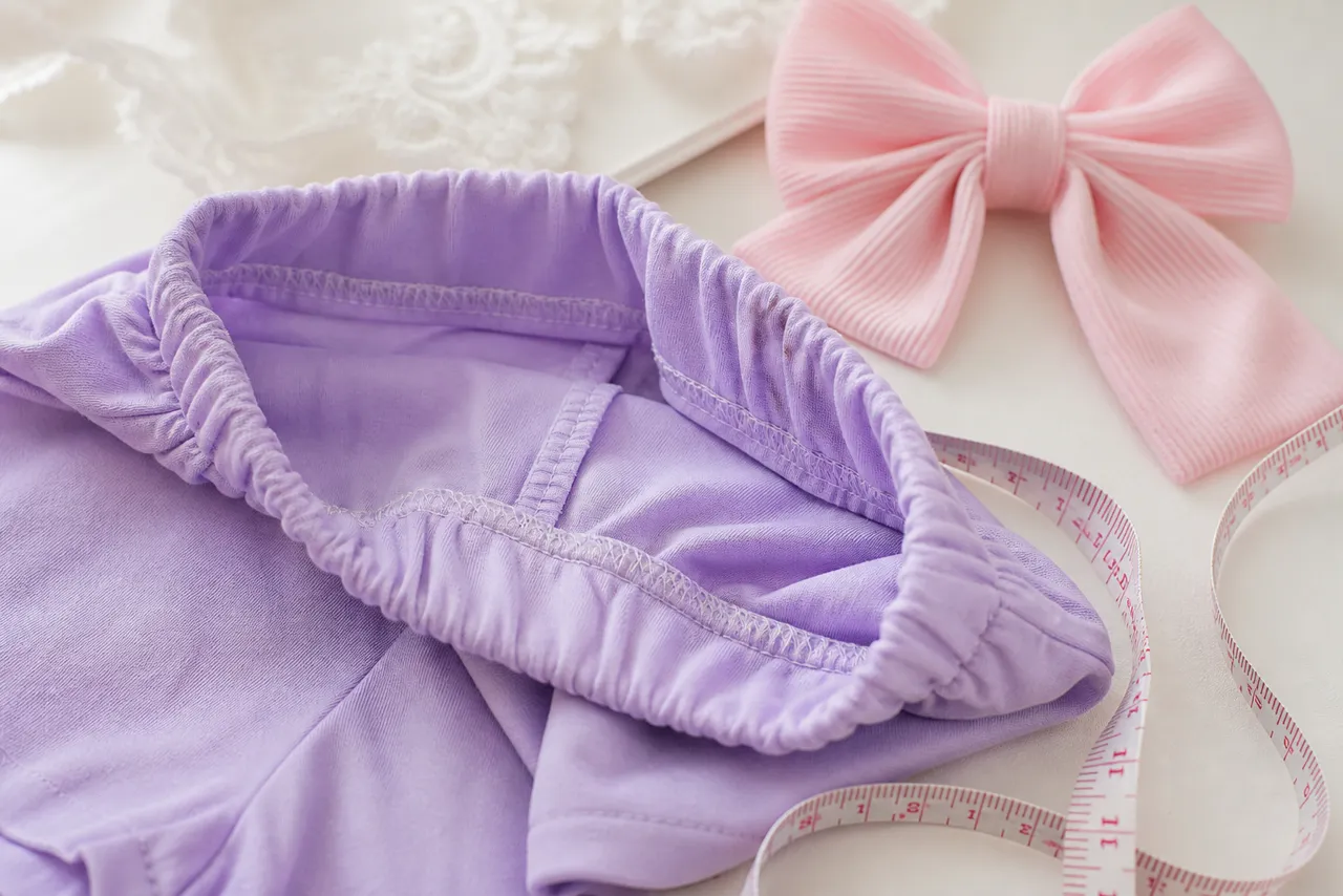 Detalhe de tecido, cós confortável, costura e fita métrica em conjunto infantil feminino